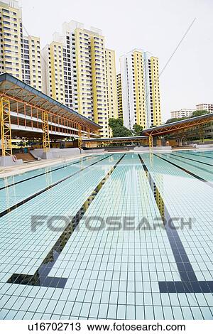 Stock Image - Swimming pool in front of buildings, Clementi Swimming Complex, Clementi, Singapore. Fotosearch