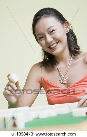 Portrait of a young woman playing with blocks and smiling View Large Photo Image Stock Image - Portrait of a young woman playing with blocks and smiling. Fotosearch