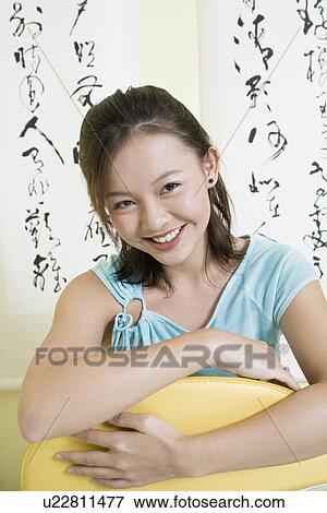 Portrait of a young woman smiling View Large Photo Image Stock Photo - Portrait of a young woman smiling. Fotosearch