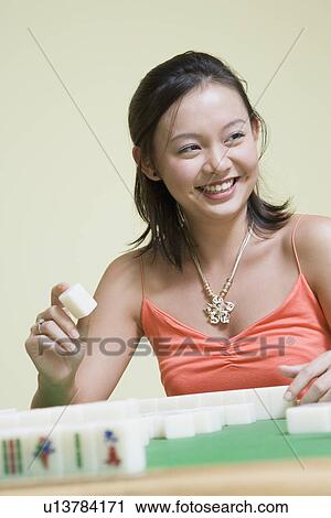 Young woman playing with blocks and smiling View Large Photo Image Stock Image - Young woman playing with blocks and smiling. Fotosearch