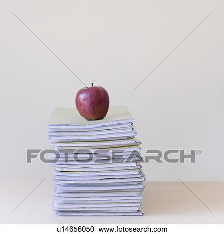 Apple on a stack of books View Large Photo Image Stock Image - Apple on a stack of books. Fotosearch
