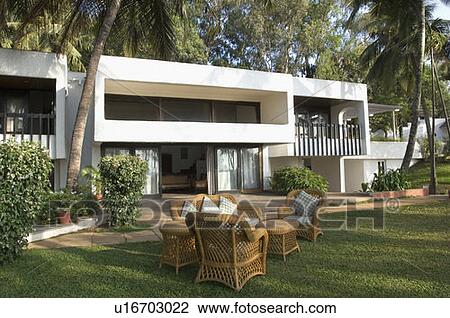Stock Image - Armchair and a couch in a lawn. Fotosearch