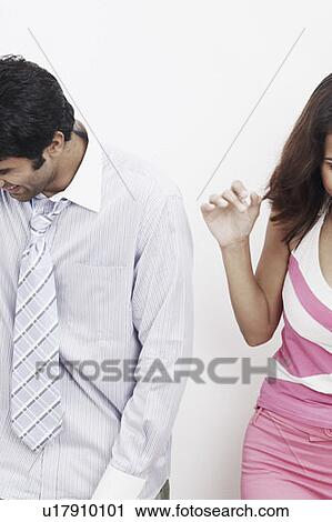 Stock Image - Businessman standing with a woman. Fotosearch