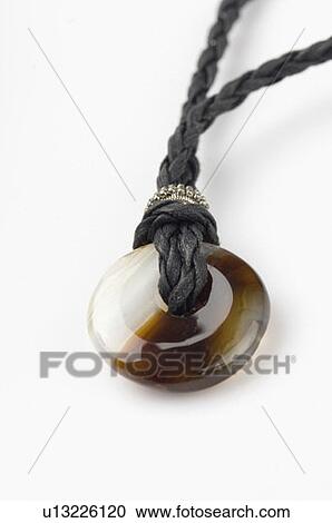 Stock Image - Close-up of a Buddhist prayer medallion. Fotosearch