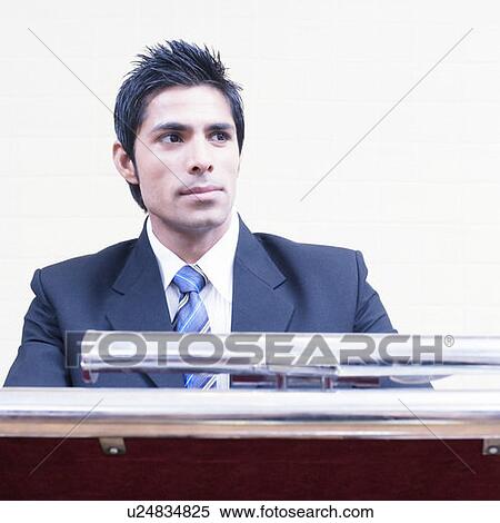 Close-up of a businessman at a lectern View Large Photo Image Stock Photography - Close-up of a businessman at a lectern. Fotosearch