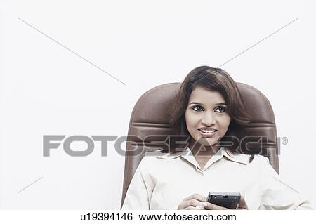 Close-up of a businesswoman holding a personal data assistant View Large Photo Image Stock Photograph - Close-up of a businesswoman holding a personal data assistant. Fotosearch