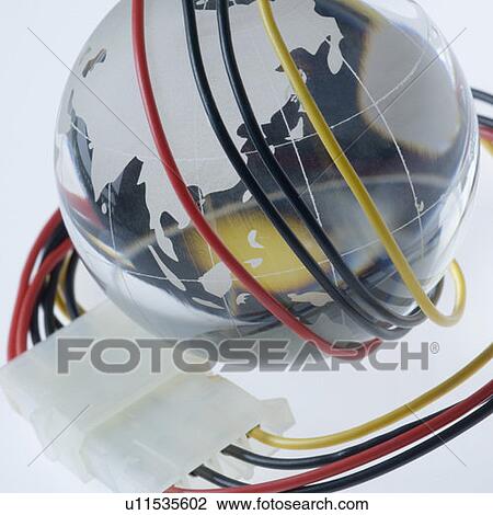 Stock Image - Close-up of a computer cable wrapped around a metal globe. Fotosearch