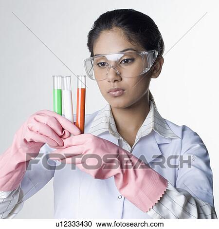 Stock Image - Close-up of a female lab technician holding test tubes. Fotosearch