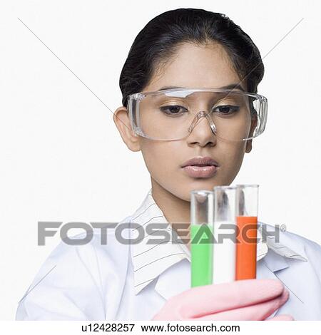 Stock Photo - Close-up of a female scientist holding test tubes in a laboratory. Fotosearch