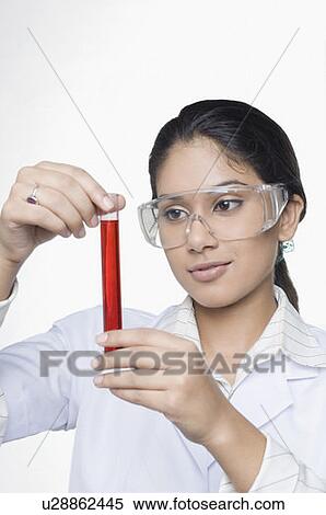 Stock Photography - Close-up of a female scientist looking at a test tube in a laboratory. Fotosearch