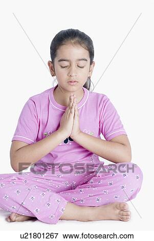 Stock Photo - Close-up of a girl in a prayer position. Fotosearch