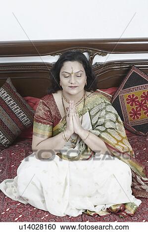 Stock Image - Close-up of a mature woman sitting with her eyes closed. Fotosearch