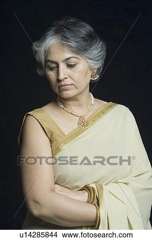 Close-up of a mature woman thinking View Large Photo Image Picture - Close-up of a mature woman thinking. Fotosearch