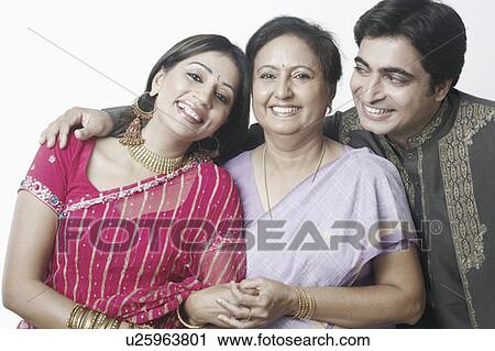 Close-up of a mid adult couple and a mature woman smiling View Large Photo Image Stock Image - Close-up of a mid adult couple and a mature woman smiling. Fotosearch