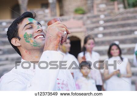 Close-up of a mid adult man drinking a glass of bhang View Large Photo Image Stock Photo - Close-up of a mid adult man drinking a glass of bhang. Fotosearch