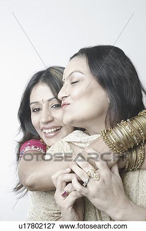 Close-up of a mid adult woman hugging a mature woman View Large Photo Image Stock Photo - Close-up of a mid adult woman hugging a mature woman. Fotosearch