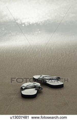 Close-up of a pair of flip-flops on the beach View Large Photo Image Stock Image - Close-up of a pair of flip-flops on the beach. Fotosearch