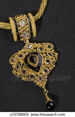 Stock Image - Close-up of a pendant of a necklace. Fotosearch