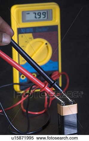 Close-up of a person's hand checking an electric cell with a multimeter View Large Photo Image Stock Photography - Close-up of a person's hand checking an electric cell with a multimeter. Fotosearch
