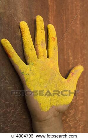 Stock Image - Close-up of a person's hand covered with powder paint. Fotosearch