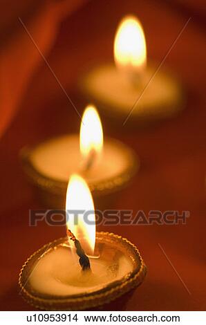 Close-up of a row of lit oil lamps View Large Photo Image Picture - Close-up of a row of lit oil lamps. Fotosearch