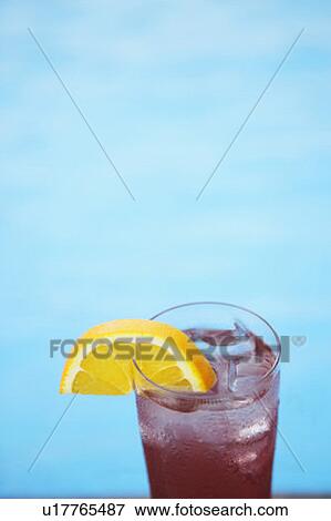Close-up of a slice of lemon on a glass of juice View Large Photo Image Stock Photo - Close-up of a slice of lemon on a glass of juice. Fotosearch