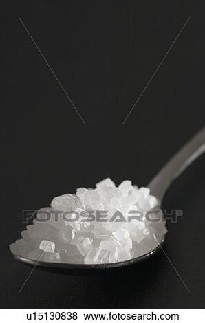 Stock Photo - Close-up of a spoon full of sugar. Fotosearch
