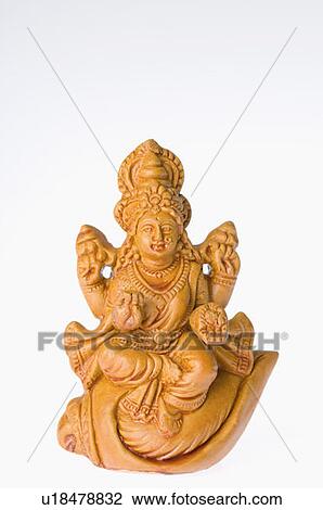 Stock Image - Close-up of a statue of Goddess Lakshmi. Fotosearch