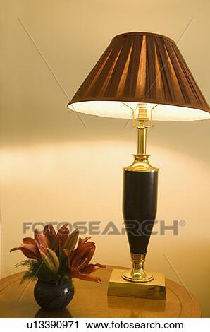 Stock Image - Close-up of a vase and a lamp shade on a table. Fotosearch