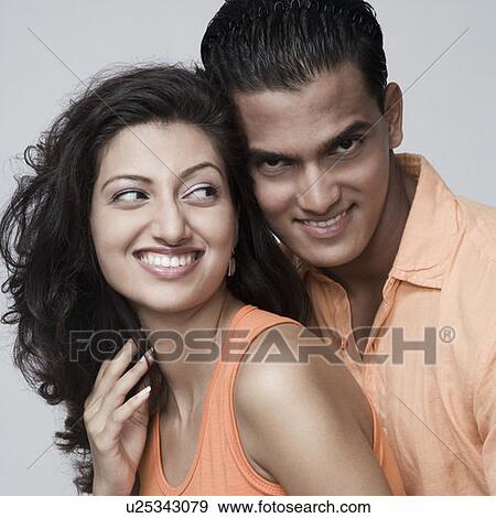 Stock Photo - Close-up of a young couple smiling. Fotosearch