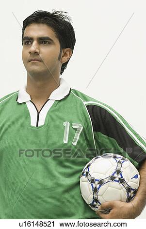 Close-up of a young man holding a soccer ball View Large Photo Image Stock Image - Close-up of a young man holding a soccer ball. Fotosearch