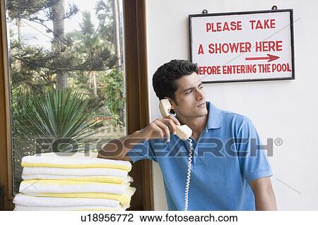 Stock Image - Close-up of a young man talking on the telephone. Fotosearch