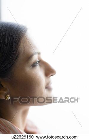 Close-up of a young woman smiling View Large Photo Image Stock Image - Close-up of a young woman smiling. Fotosearch