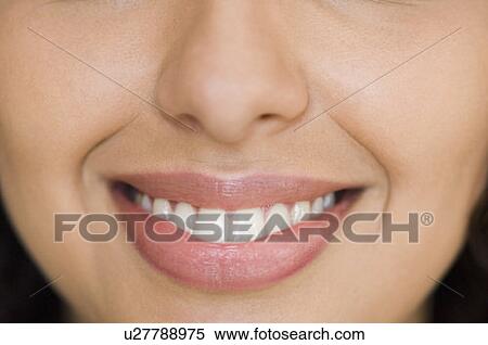 Close-up of a young woman smiling View Large Photo Image Stock Photography - Close-up of a young woman smiling. Fotosearch