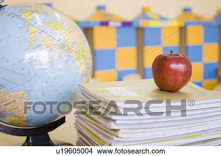 Close-up of an apple kept on a stack of books View Large Photo Image Picture - Close-up of an apple kept on a stack of books. Fotosearch