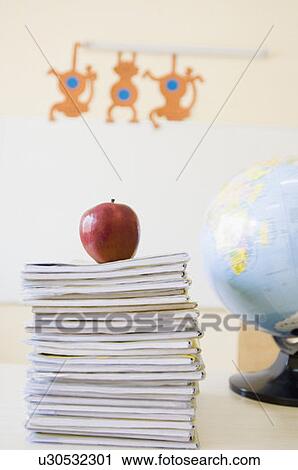 Close-up of an apple kept on a stack of books View Large Photo Image Stock Image - Close-up of an apple kept on a stack of books. Fotosearch