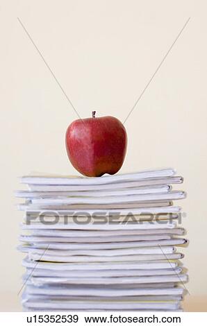 Close-up of an apple kept on a stack of books View Large Photo Image Stock Photo - Close-up of an apple kept on a stack of books. Fotosearch