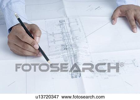 Close-up of an architect's hands drawing a blueprint View Large Photo Image Stock Photo - Close-up of an architect's hands drawing a blueprint. Fotosearch