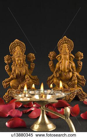 Close-up of an oil lamp burning in front of religious idols View Large Photo Image Stock Photography - Close-up of an oil lamp burning in front of religious idols. Fotosearch