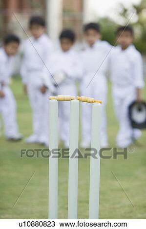 Close-up of cricket stump with cricket players standing in the background View Large Photo Image Stock Image - Close-up of cricket stump with cricket players standing in the background. Fotosearch
