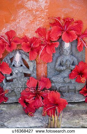 Stock Photo - Close-up of flowers on the statues of God and Goddess Durga. Fotosearch