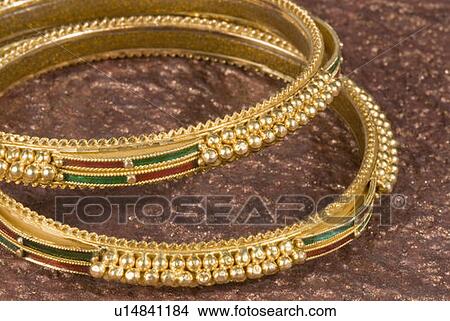 Picture - Close-up of golden bracelets. Fotosearch