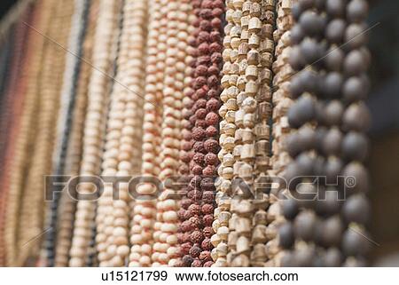 Close-up of necklaces hanging in a row, Pushkar, Rajasthan, India View Large Photo Image Stock Photo - Close-up of necklaces hanging in a row, Pushkar, Rajasthan, India. Fotosearch