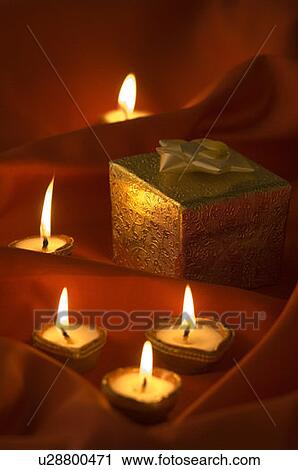 Close-up of oil lamps near a gift box View Large Photo Image Stock Image - Close-up of oil lamps near a gift box. Fotosearch