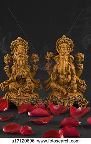 Close-up of rose petals in front of religious idols View Large Photo Image Stock Photograph - Close-up of rose petals in front of religious idols. Fotosearch