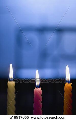 Stock Photography - Close-up of three burning candles. Fotosearch