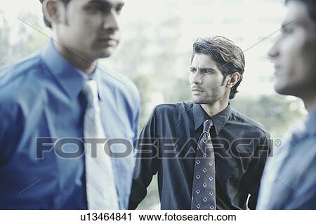 Stock Image - Close-up of three businessmen. Fotosearch