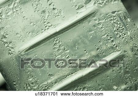 Close-up of water droplets on a bottle surface View Large Photo Image Stock Image - Close-up of water droplets on a bottle surface. Fotosearch