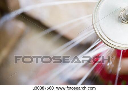 Stock Image - Close-up of water running out of a shower head. Fotosearch