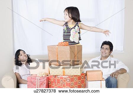 Couple smiling with their daughter View Large Photo Image Stock Photo - Couple smiling with their daughter. Fotosearch